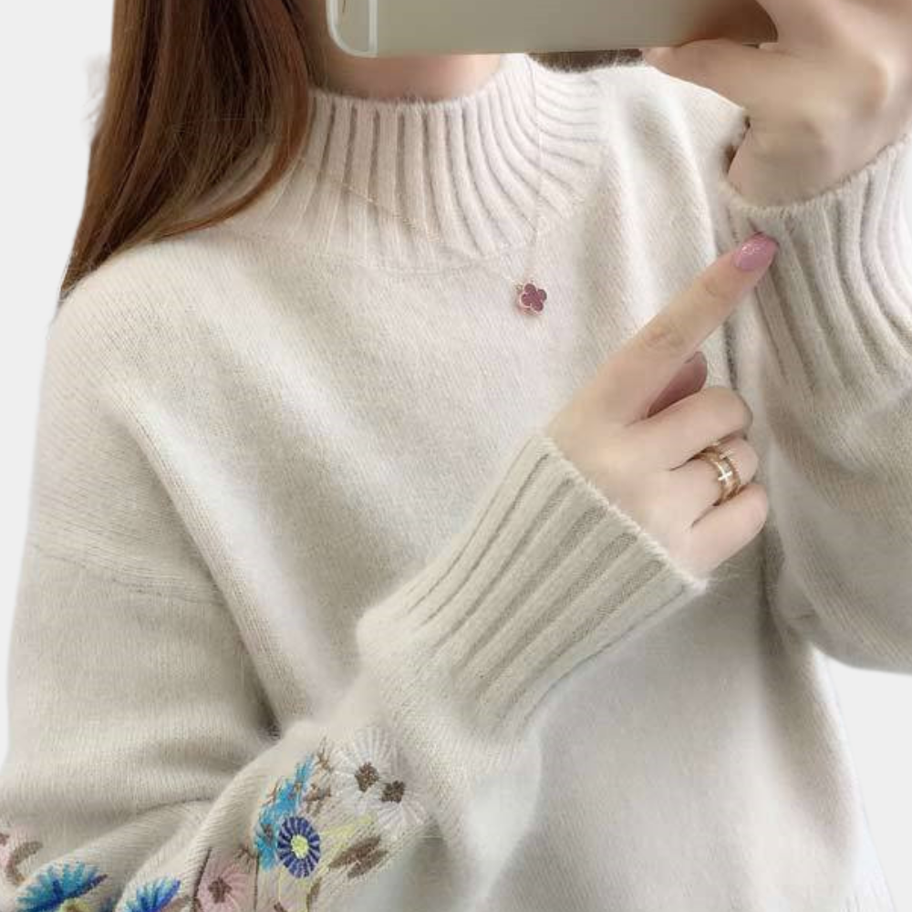 Blomst i ærmestrikket sweater
