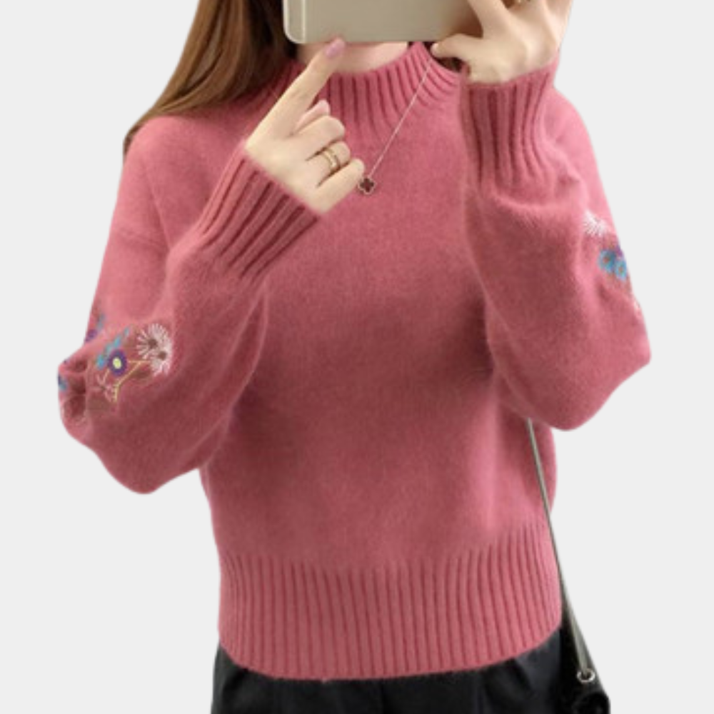 Blomst i ærmestrikket sweater