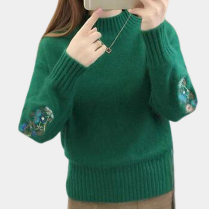Blomst i ærmestrikket sweater