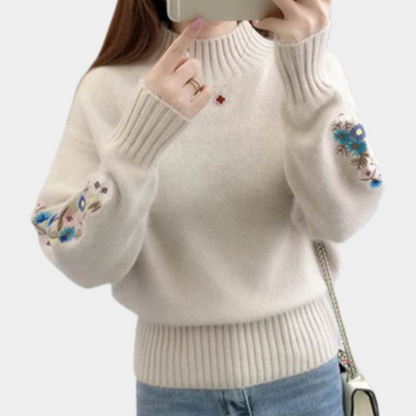 Blomst i ærmestrikket sweater